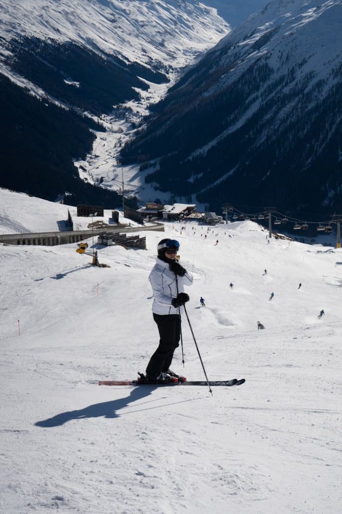 Skier on a snowy slope in Klosters-Serneus, Switzerland with mountain views.